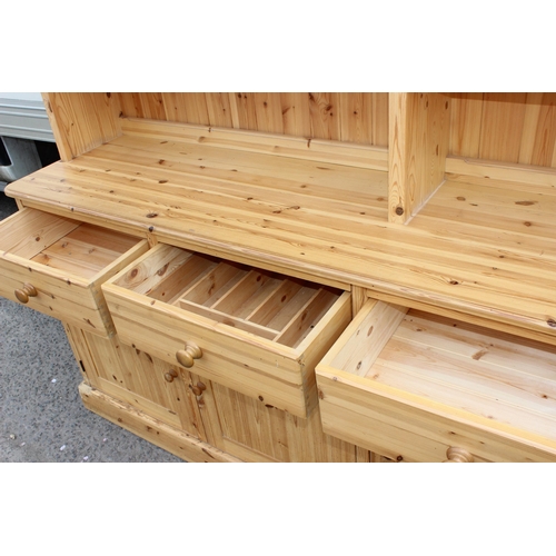 59 - A large glazed pine dresser with 4 cupboards to base, approx 230cm wide x 52cm deep x 221cm tall