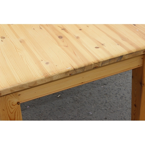 55 - A contemporary pine farmhouse kitchen table, approx 131cm wide x 91cm deep x 77cm tall