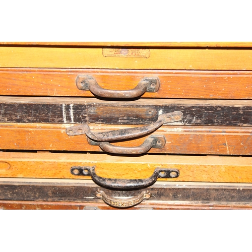 43 - A vintage Caslon Machinery printer's chest of drawers with a harlequin mix of drawers and handles, a... 