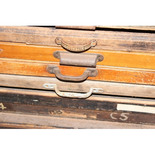 43 - A vintage Caslon Machinery printer's chest of drawers with a harlequin mix of drawers and handles, a... 