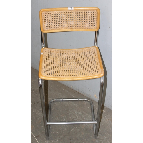 72 - In the manner of Marcel Breuer, a Cesca style cantilever bar stool, with woven cane seat and back, a... 