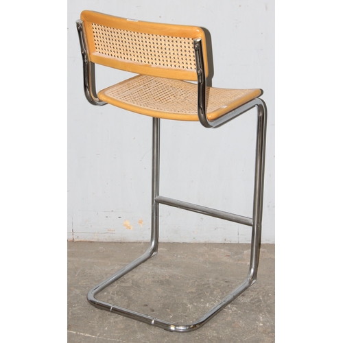 72 - In the manner of Marcel Breuer, a Cesca style cantilever bar stool, with woven cane seat and back, a... 