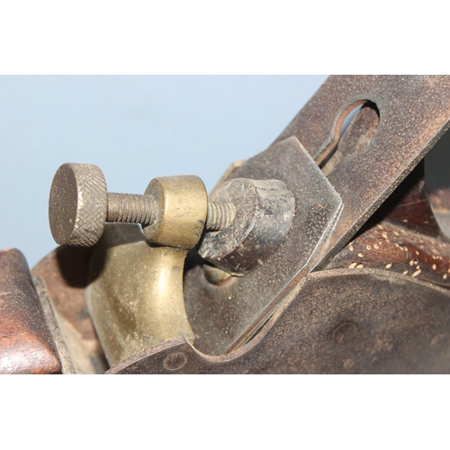 806 - An antique brass and steel woodworking plane with wooden handle, seemingly unmarked but of excellent... 