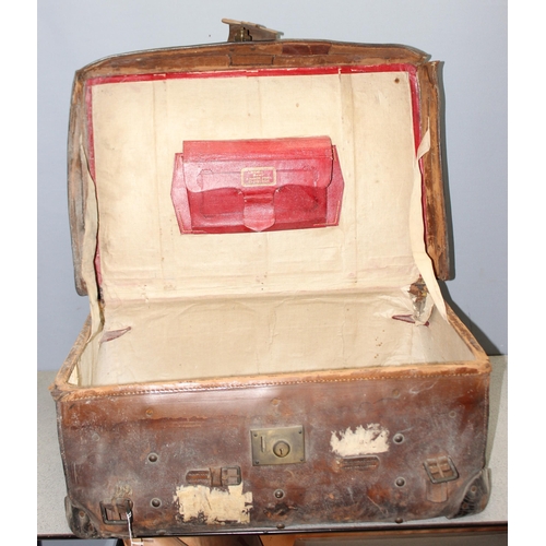 82 - A vintage leather travel trunk with a large number of period labels, by A. Boswell of Edinburgh, app... 