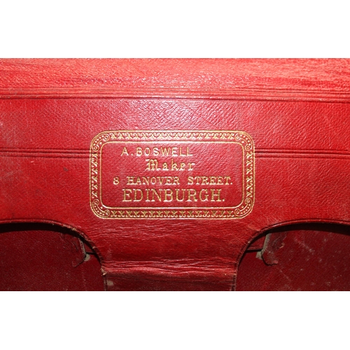 82 - A vintage leather travel trunk with a large number of period labels, by A. Boswell of Edinburgh, app... 