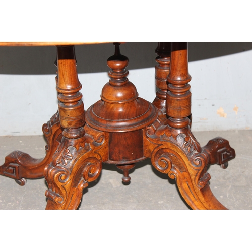 9 - A 19th century tilt-topped walnut oval table with Tunbridgeware inlay and carved pedestal base, appr... 