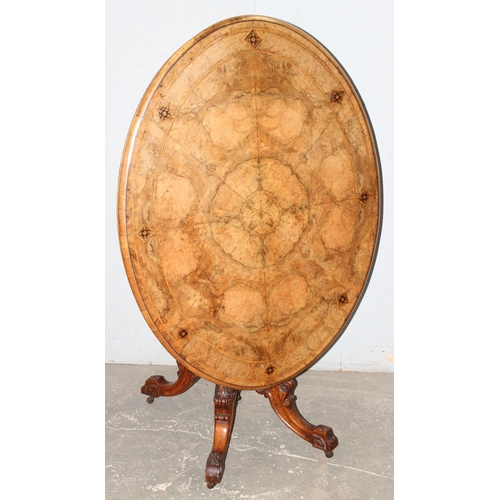 9 - A 19th century tilt-topped walnut oval table with Tunbridgeware inlay and carved pedestal base, appr... 