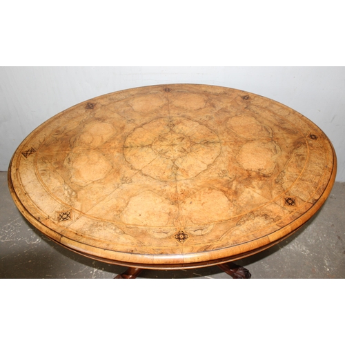 9 - A 19th century tilt-topped walnut oval table with Tunbridgeware inlay and carved pedestal base, appr... 