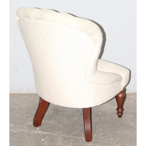 106 - An antique style button backed nursing chair with wooden legs