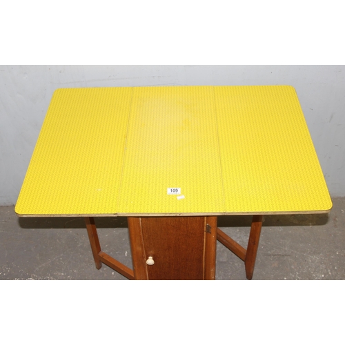 109 - A vintage yellow Formica topped drop leaf dining table, approx 91cm wide x 61cm deep x 76m tall