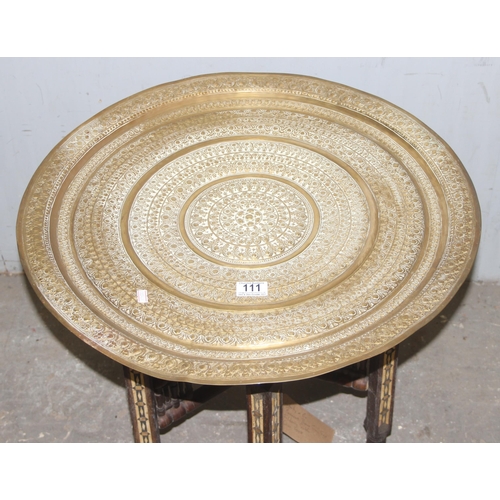 111 - A brass topped folding Benares table with pattern detailing and folding wooden base, approx 60cm wid... 