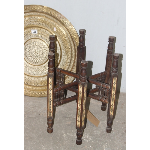 111 - A brass topped folding Benares table with pattern detailing and folding wooden base, approx 60cm wid... 