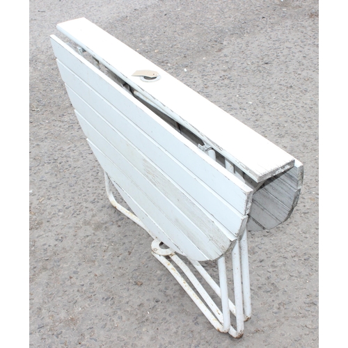 300 - A white painted folding wooden garden table with metal base, approx 100cm wide x 100cm deep x 66cm t... 