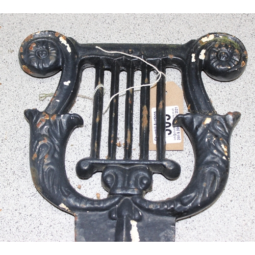 303 - Georgian style cast iron boot scraper of neo-classical lyre design, approx 33cm x 45cm