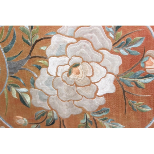 428 - Chinese embroidered silk panel in glazed gilt bamboo effect frame of floral design on peach coloured... 