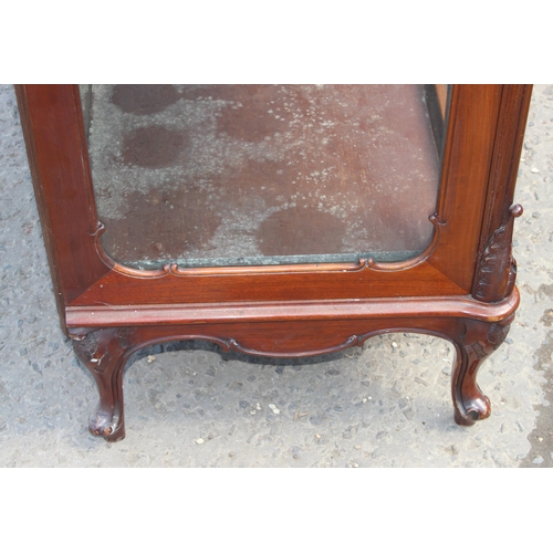 89 - A Continental carved mahogany display cabinet with velvet lines shelves and mirrored back, likely 19... 