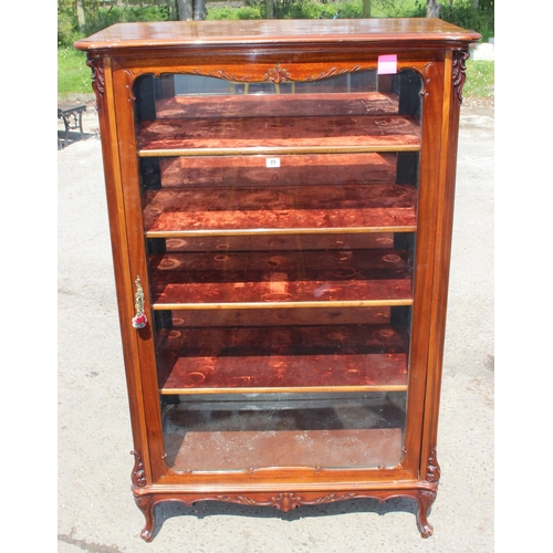 89 - A Continental carved mahogany display cabinet with velvet lines shelves and mirrored back, likely 19... 