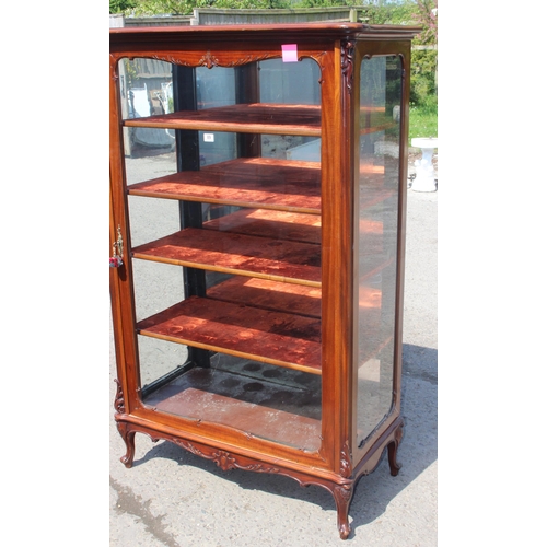 89 - A Continental carved mahogany display cabinet with velvet lines shelves and mirrored back, likely 19... 