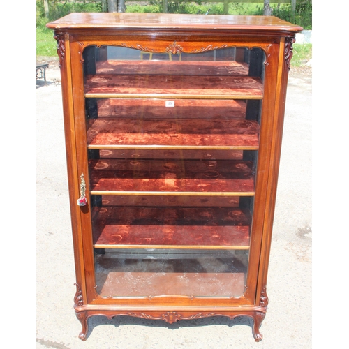 89 - A Continental carved mahogany display cabinet with velvet lines shelves and mirrored back, likely 19... 