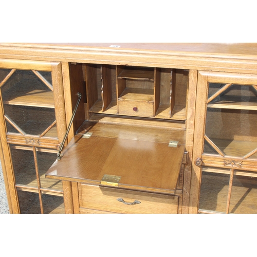 120 - A decorative Art Deco period light oak bureau with glazed bookcase sides, approx 120cm wide x 34cm d... 