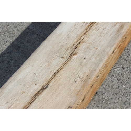 121 - A long rustic pine low bench, approx 255cm wide x 28cm deep x 39cm tall