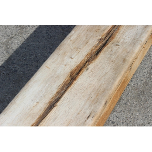 121 - A long rustic pine low bench, approx 255cm wide x 28cm deep x 39cm tall