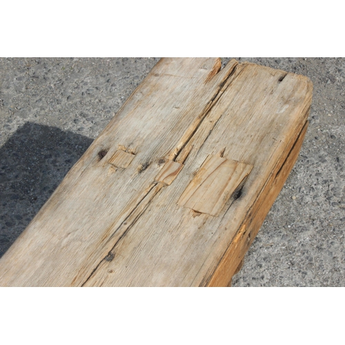 121 - A long rustic pine low bench, approx 255cm wide x 28cm deep x 39cm tall