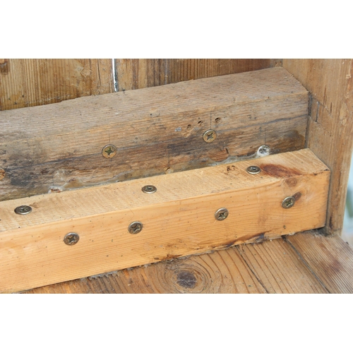 121 - A long rustic pine low bench, approx 255cm wide x 28cm deep x 39cm tall