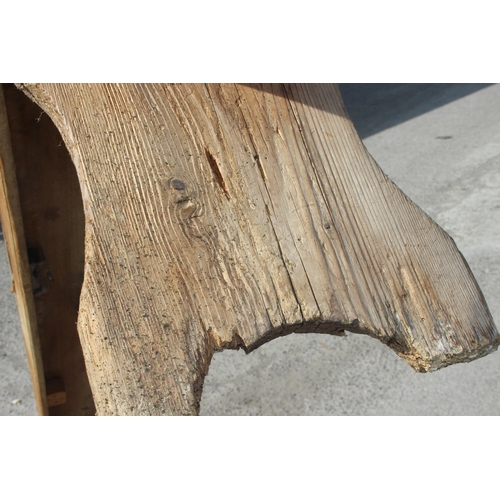 121 - A long rustic pine low bench, approx 255cm wide x 28cm deep x 39cm tall