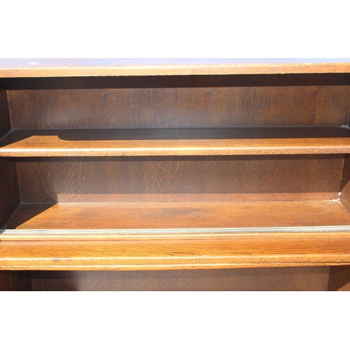 124 - A vintage oak waterfall bookcase or display shelf, approx 122cm wide x 36cm deep x 122cm tall