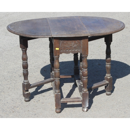 125 - A small antique oak drop leaf table with carved details, approx 77cm wide x 35cm deep (105cm fully e... 