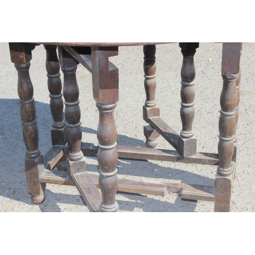 125 - A small antique oak drop leaf table with carved details, approx 77cm wide x 35cm deep (105cm fully e... 