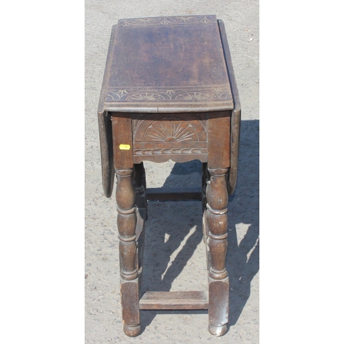 125 - A small antique oak drop leaf table with carved details, approx 77cm wide x 35cm deep (105cm fully e... 