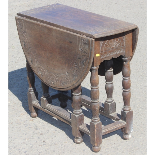 125 - A small antique oak drop leaf table with carved details, approx 77cm wide x 35cm deep (105cm fully e... 