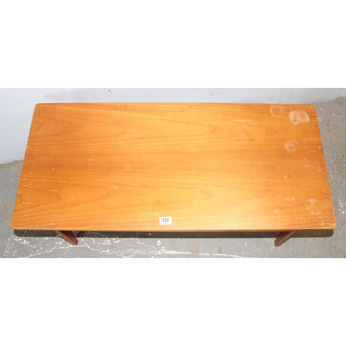 131 - Retro wooden coffee table with magazine shelf, approx 107cm W x 50cm D x 46H