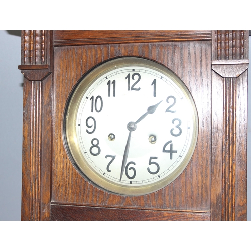 1338 - Arts and crafts period oak wall hanging clock with pendulum, key and silver plated dedication plaque... 