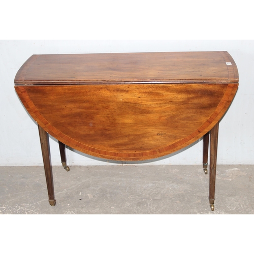 135 - An antique mahogany drop leaf table, 19th century, approx 110cm wide x 40cm deep (124cm fully extend... 