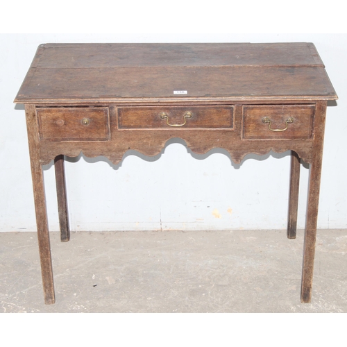 136 - A Georgian oak console table or lowboy with 3 drawers, approx 92cm wide x 49cm deep x 73cm tall