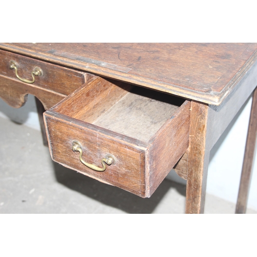 136 - A Georgian oak console table or lowboy with 3 drawers, approx 92cm wide x 49cm deep x 73cm tall