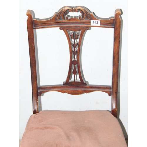 142 - An antique low or nursing chair with upholstered seat and carved details, approx 80cm tall