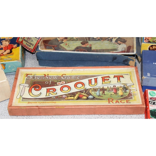 1544 - Box of vintage board and other games to include blow football, spring rings and a parachute fighter