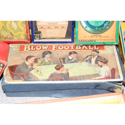 1544 - Box of vintage board and other games to include blow football, spring rings and a parachute fighter