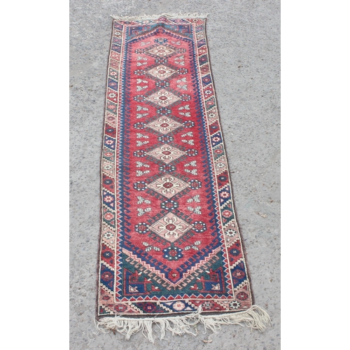 203 - Vintage hall runner rug of red ground, possibly Kurdish, approx 335cm x 80cm