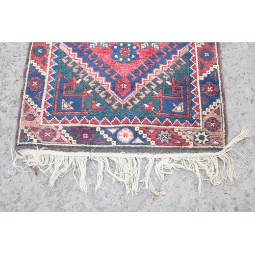 203 - Vintage hall runner rug of red ground, possibly Kurdish, approx 335cm x 80cm