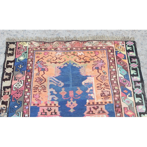 212 - A vintage Baluch style prayer rug of red and blue ground, approx 150cm x 85cm