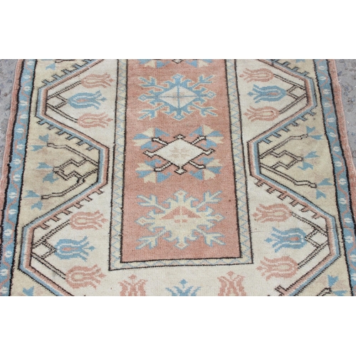 215 - A vintage orange and yellow ground rug, approx 130cm x 85cm