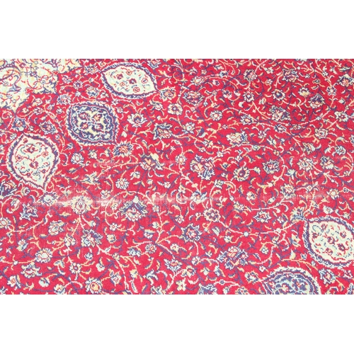 219 - A large Persian style highly decorative red ground rug, approx 320cm x 275cm