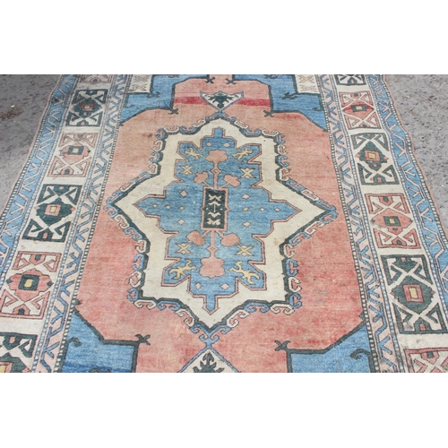 220 - A large vintage Anatolian style orange and blue ground geometric rug, approx 280cm x 162cm