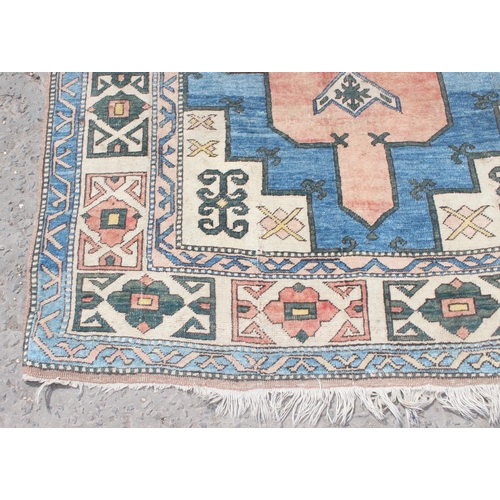 220 - A large vintage Anatolian style orange and blue ground geometric rug, approx 280cm x 162cm