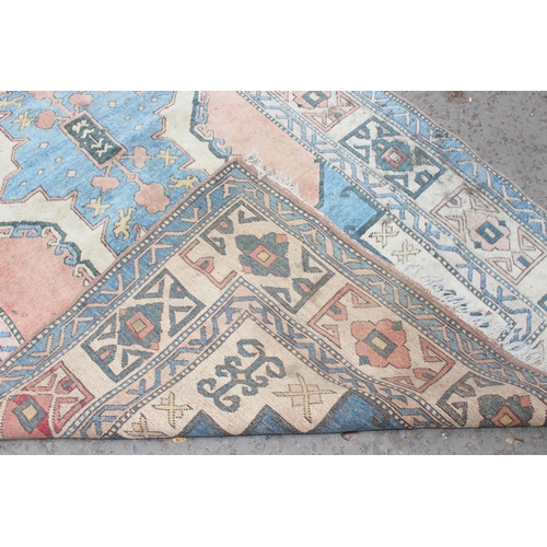 220 - A large vintage Anatolian style orange and blue ground geometric rug, approx 280cm x 162cm